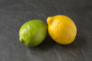 Lemon and Lime on slate background