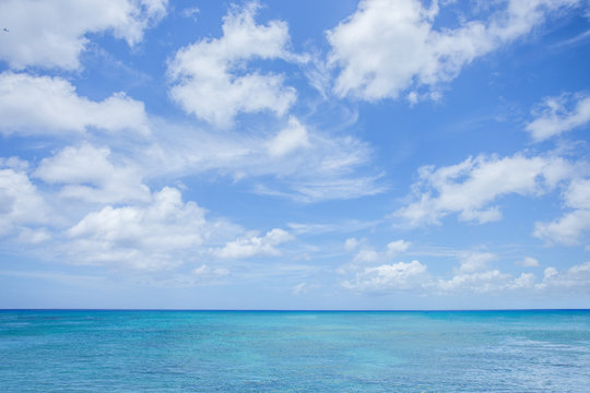 Sea with clouds blue sky background