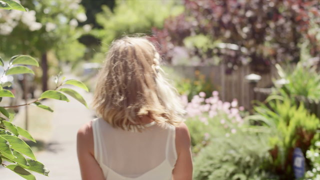 Young blonde woman or model walking down the street