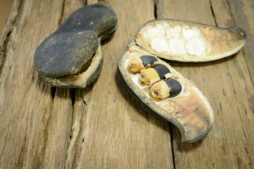 Seeds of Afzelia xylocarpa (Kurz) Craib on wood table