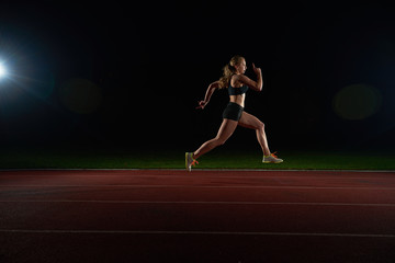 Athletic woman running on track