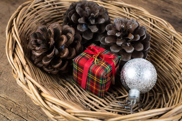 Gift box and pine cones in Wicker baskets