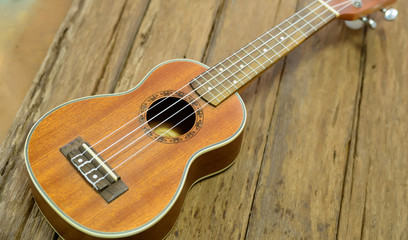 Fototapeta na wymiar Close up ukuleles on wooden background.
