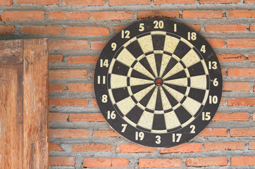 dartboard on brick wall 