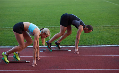 athlete woman group  running on athletics race track