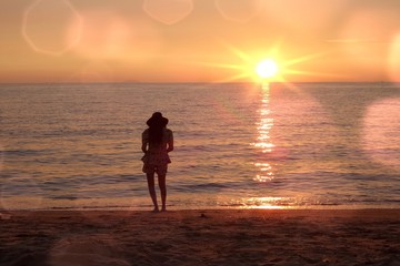 Fototapeta premium girl looking sunset on beach. 