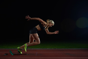 woman  sprinter leaving starting blocks