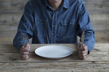 Man has a knife and fork
