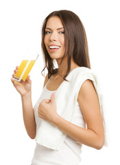 Smiling brunette woman drinking lemon or orange citrus juice, is