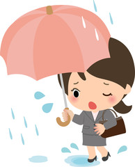 雨の中を通勤するスーツの女性