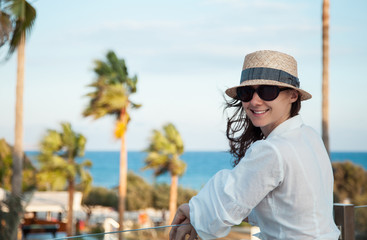 Fototapeta premium Portrait of a happy young woman near the sea
