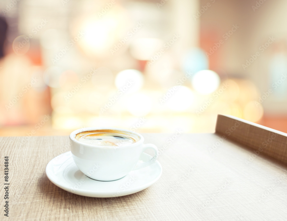 Aufkleber espresso coffee cup on wood table in cafe with bokeh light backg