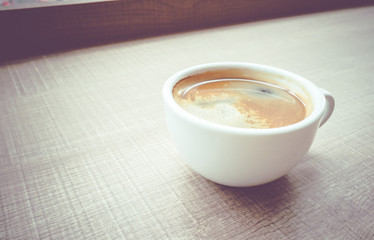 Vintage filter :Close up Espresso Coffee cup on wood table in ca