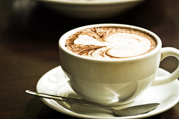 cappuccino in a white cup on a white plate
