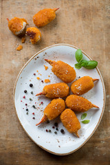 Glass plate with roasted breaded crab claws, above view