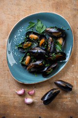 Above view of steamed mussels with sea salt and chopped parsley