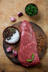 Beef barbecue steak with herbs and spices, rustic wooden surface