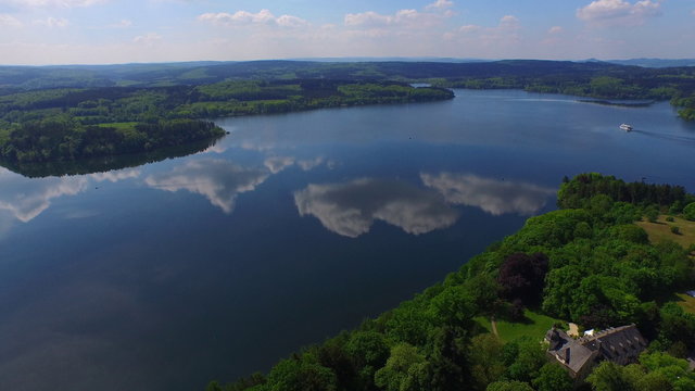 aerial view of a sunny lake with clouds in the water