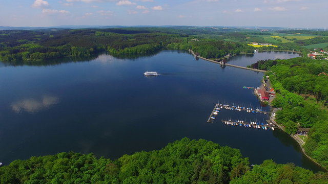 aerial view of a sunny lake with ship