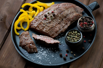 Medium grilled beef barbecue steak on a frying pan, studio shot