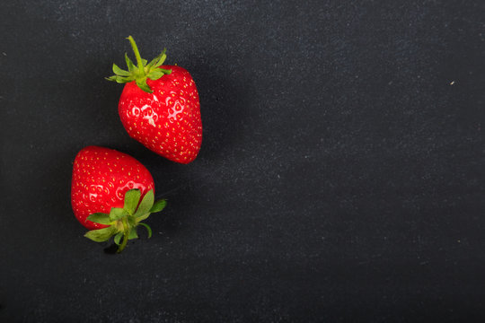 Concept of strawberries on dark chalkboard