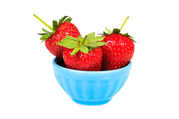 Strawberries in blue cup isolated on white background