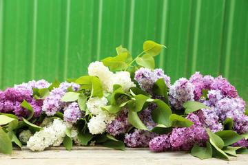 Beautiful lilac on grey wooden background