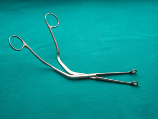 a pair of stainless steel surgical forceps