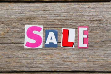 Fototapeta premium The word sale in cut out magazine letters
