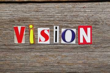 The word vision in cut out magazine letters