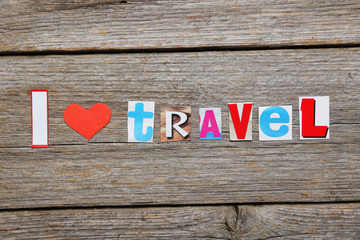The word I love travel in cut out magazine letters
