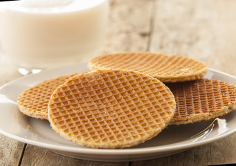 Dutch Waffles close up on wooden table with glass of milk