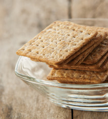 Cracker close up on white plate in wooden background