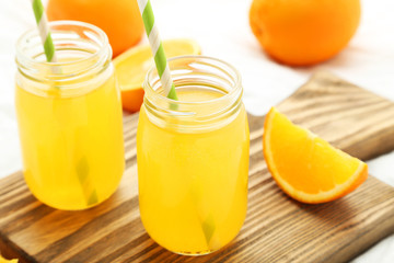 Orange juice in bottle on cutting board