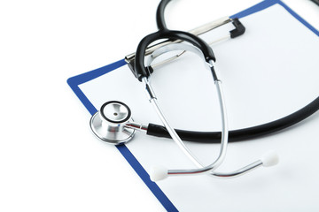 Stethoscope with tablet for notes on white background