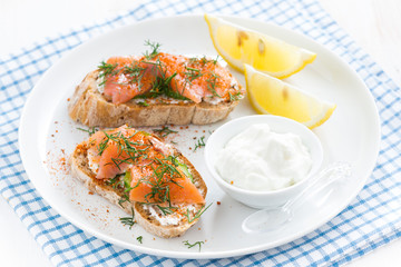 bread with salted salmon and cream cheese on a plate