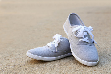 Naklejka premium Pair of grey shoes outdoors