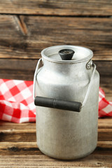 Can for milk on brown wooden background