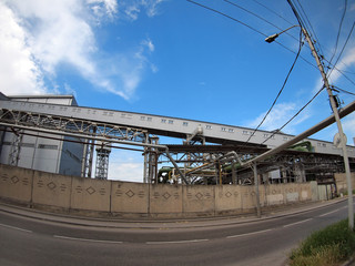 Obraz premium Industrial buildings behind a fence facing the road