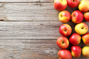 Red apples on grey wooden background