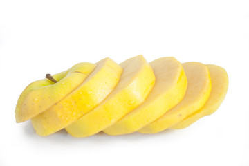 Single yellow apple cut into diagonal slices