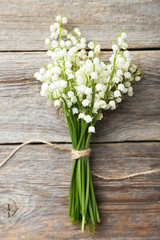 Lily of the Valley on grey wooden background