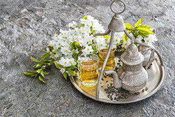 Tea glasses and pot. Oriental holidays decoration. Silver Tablew