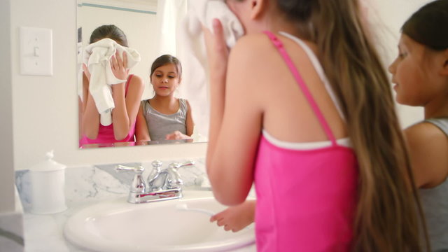 Two Adorable Little Girls Share The Bathroom As They Get Ready For Bedtime