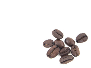 Close-up of roasted coffee beans heap isolated on white