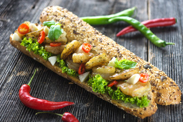 Sandwich with shrimps crispy baguette on a wooden background