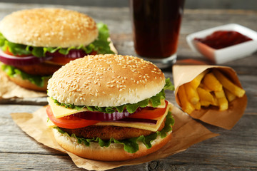 Fresh burgers on grey wooden background