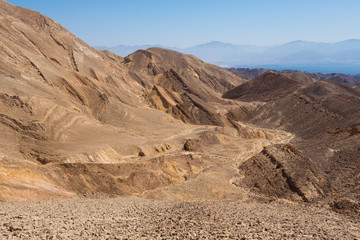 Desert rocks mountains and Eilat Red sea bay.
