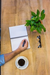Man writing in notepad