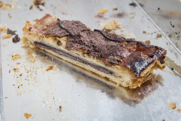 Chocolate pastry piece with crumbs